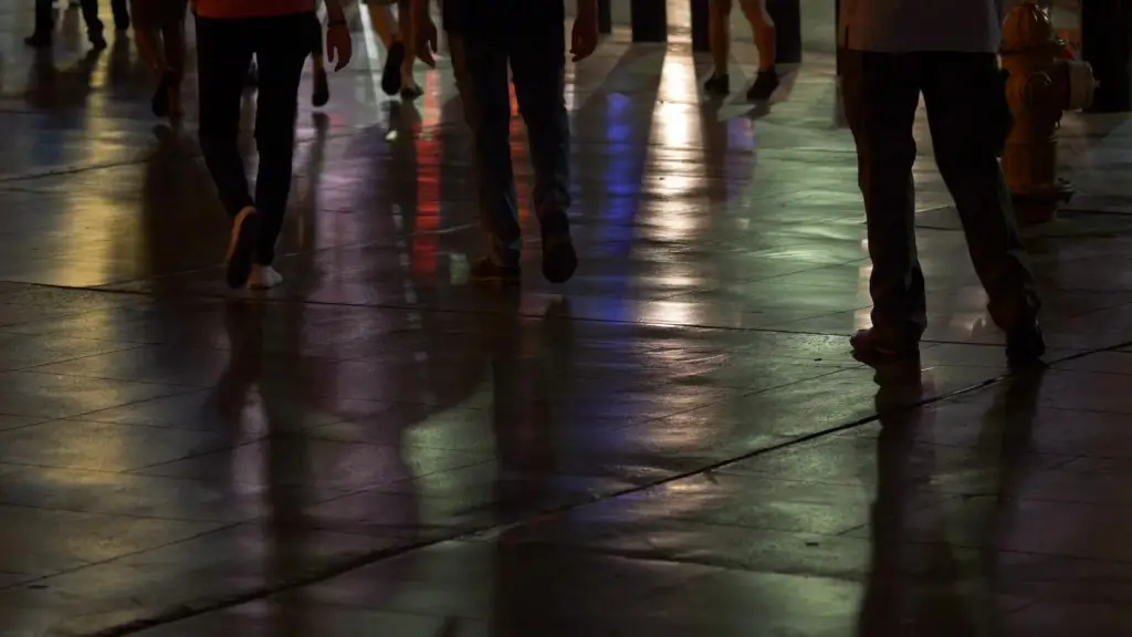 Neon reflections on a wet sidewalk